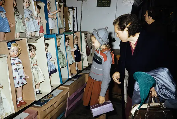 Russia, woman and girl looking at dolls for sale at store in Moscow