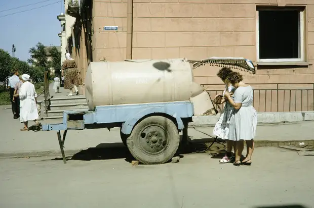 Russia, women making purchase from milk truck. Siberia
