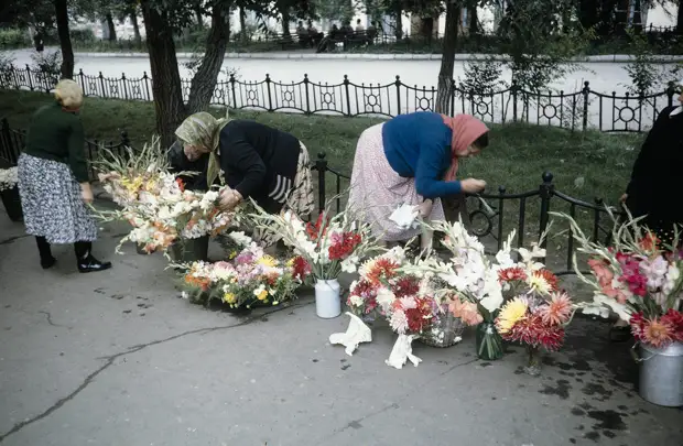 Russia, women selling flowers on sidewalk in Khabarovsk