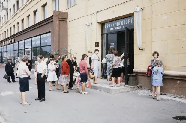 Russia, people waiting in line to enter shop